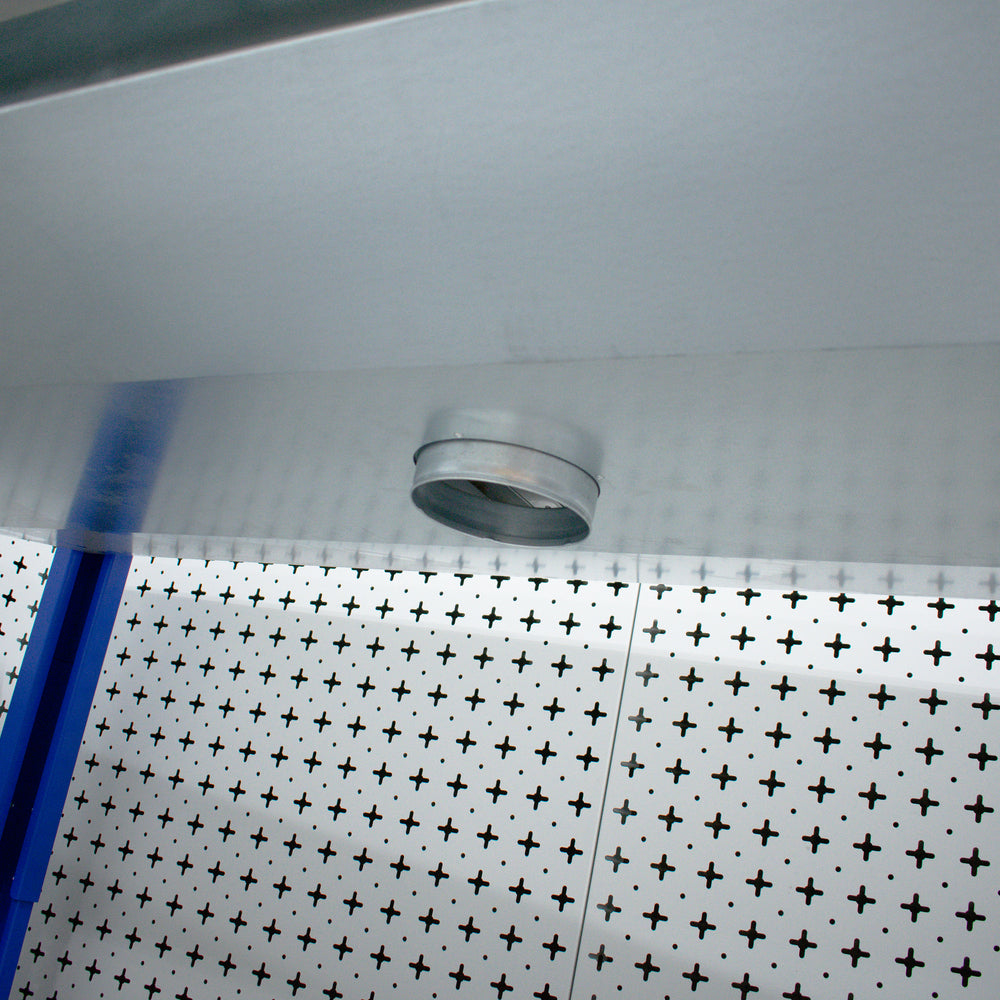 Metallic shower head on a tiled wall with a cross pattern