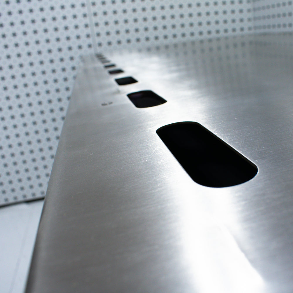 Industrial custom downdraft table surface with a textured pattern and cutouts