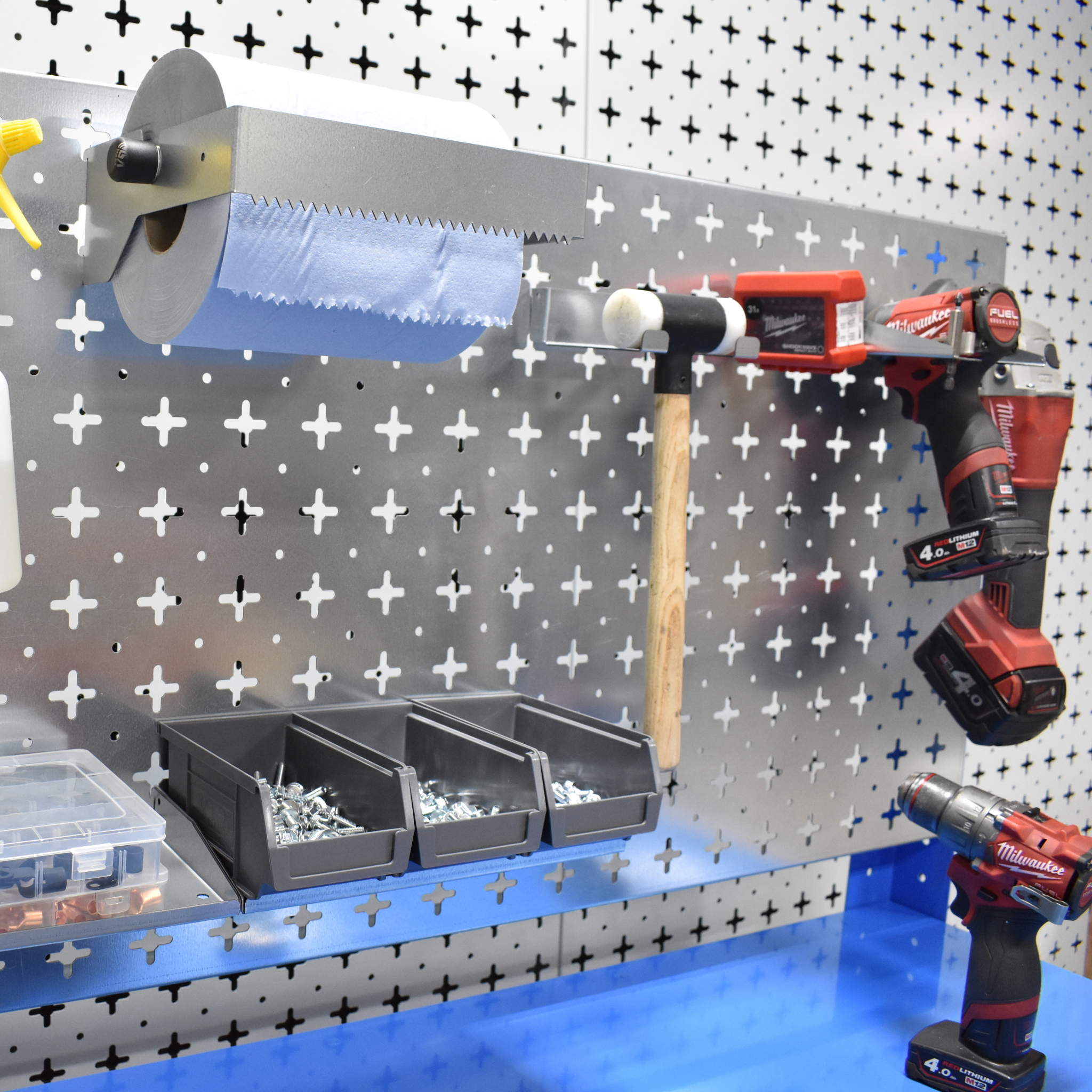 Wall-mounted tool organizer with tools and storage bins on a pegboard.