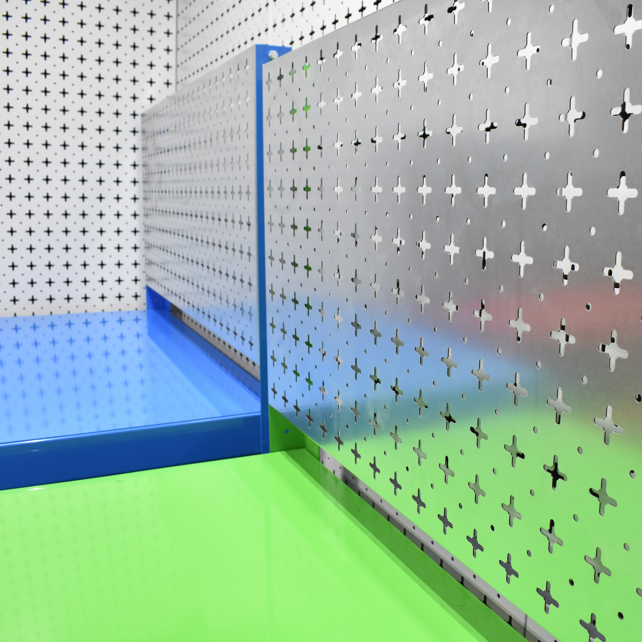 Pegboard wall with colorful baseboards in a room setting