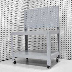 Metal workbench with pegboard against a patterned wall