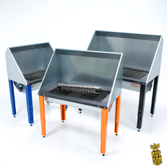 Three metal downdraft plasma cutting tables with different colour legs on a white background