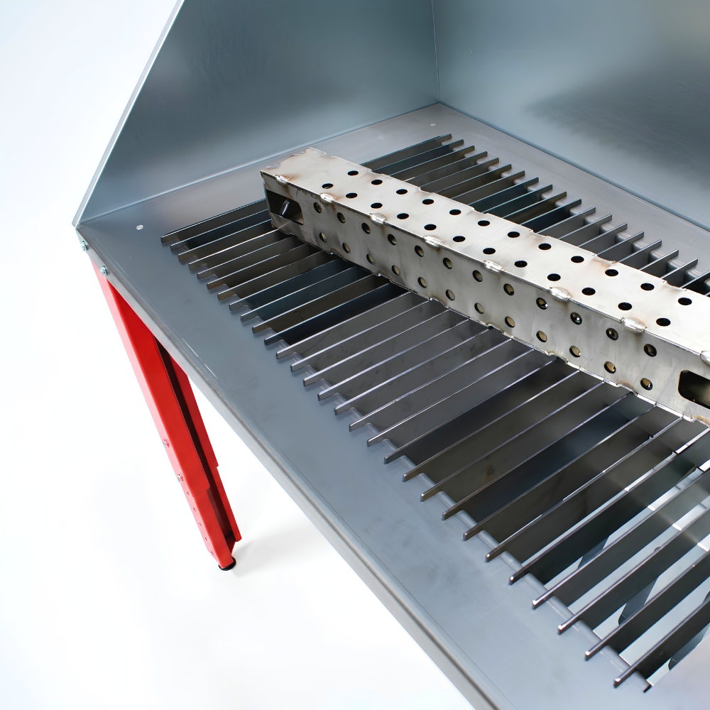 Plasma cutting table with perforated work surface on a white background