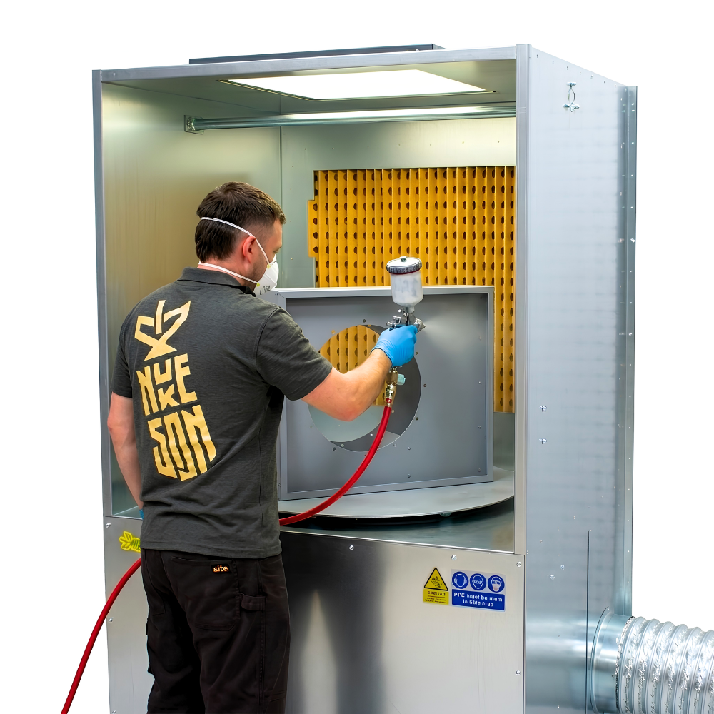 Industrial ATEX spray booth with turntable on white background with person spray painting a product