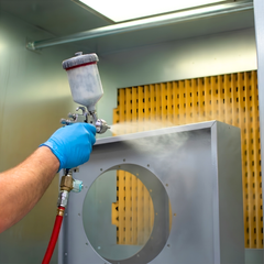 Industrial ATEX spray booth close up spray paint gun and grey product