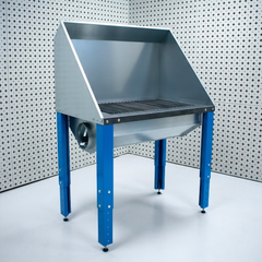 Plasma cutting table with blue legs against a patterned wall