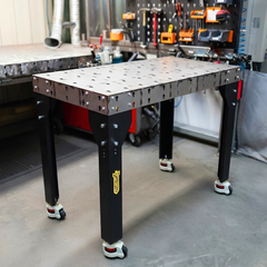 Welding table with black legs in an industrial workshop
