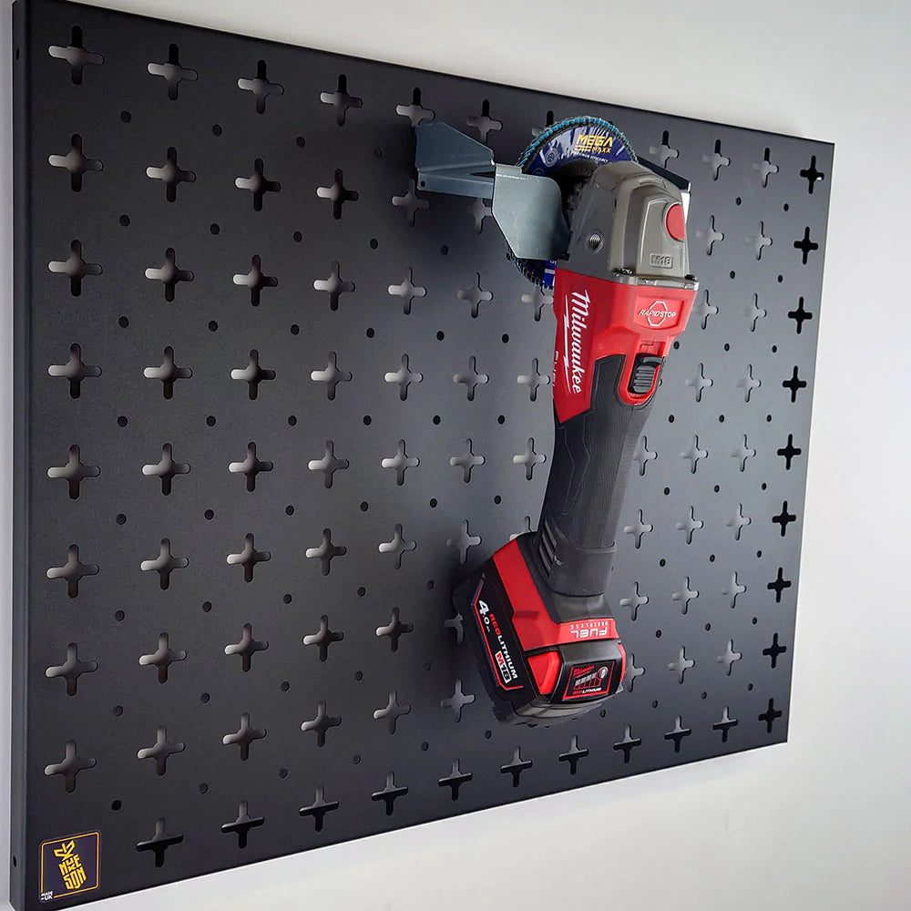 Nukeson tool wall galvanised steel angle grinder holder, with angle grinder in the bracket, on a black organiser panel