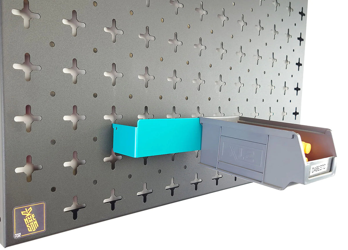 A aqua blue Nukeson tool wall XL box holding bracket, with a black plastic XL storage box attached, mounted on a black wall organiser panel