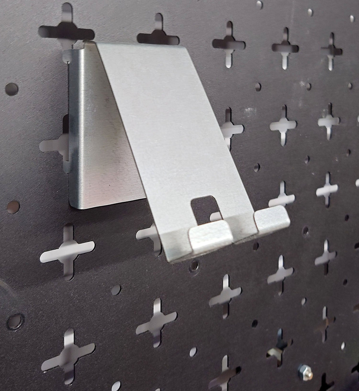 Galvanised Steel Nukeson Peboard Tool Wall phone holder attatchment, on a black pegboard wall